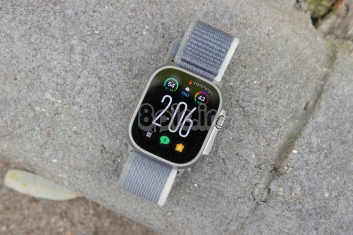 اپل واچ اولترا 2 روی زمین دراز کشیده و صفحه ساعت مدولار اولترا را نشان می دهد.